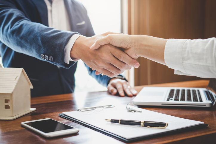 Shaking hands over the sale of a home.