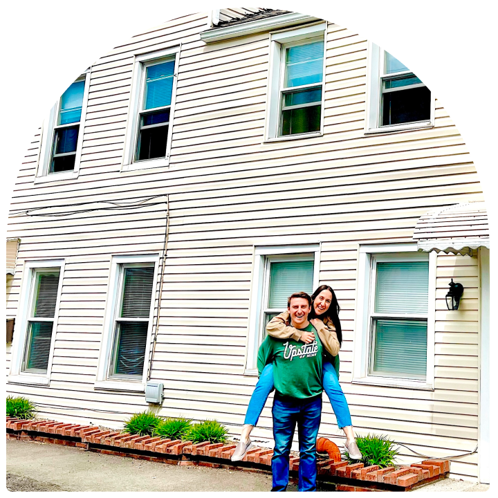 The Lupos in front of another of their homes.