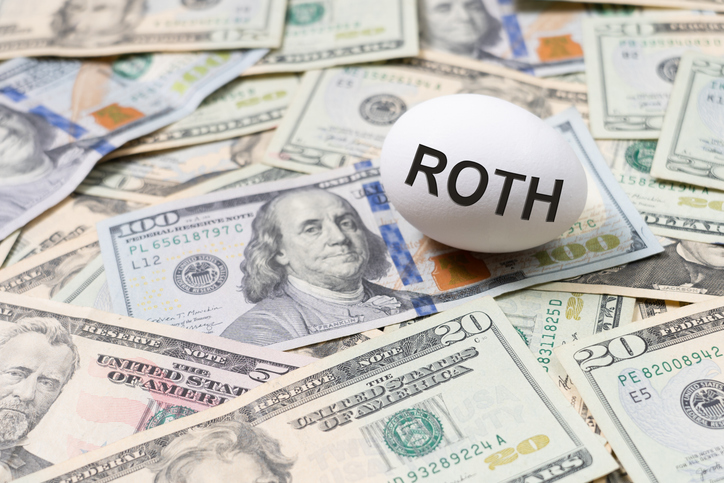 An egg labeled "Roth" placed on a bed of U.S. dollar bills.